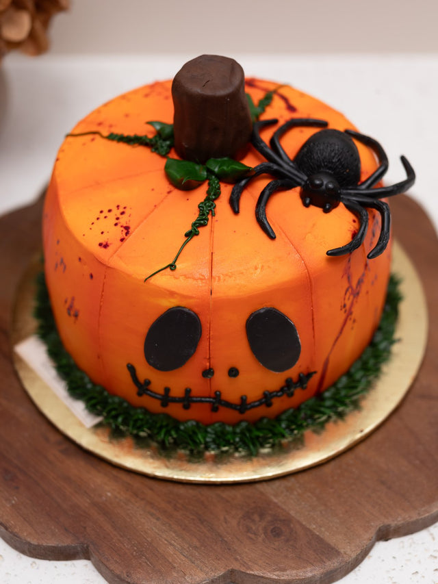 Jack-o-lantern pumpkin cake with a spider