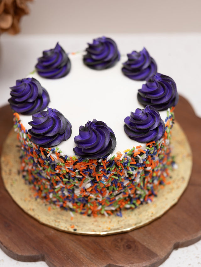 Fall sprinkle cake with purple buttercream swirls